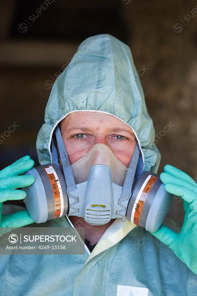 Farmer wearing protective suit and mask when applying chemicals on fields. This farmer uses sustainable farming practises in using reasonable amount of inputs (herbicides, pesticides).