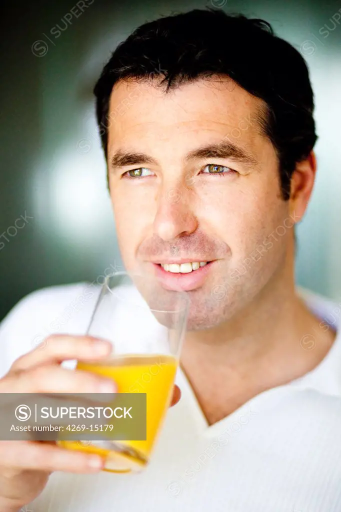 Man drinking fruit juice.