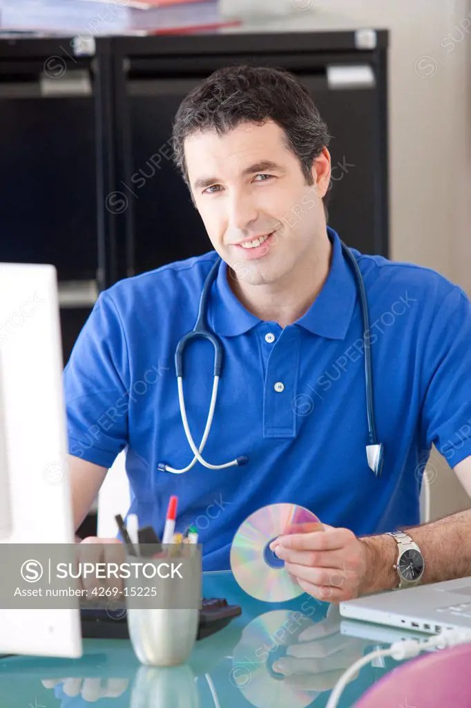 General practitioner using computer in the consulting room.