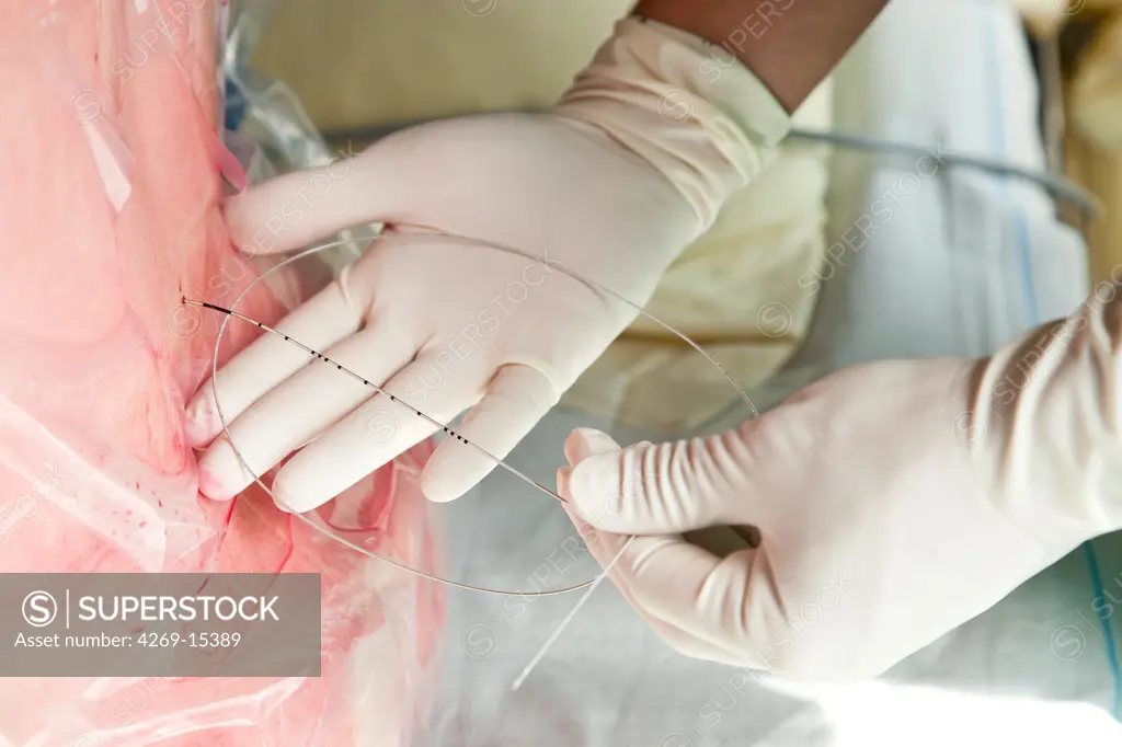 Woman receiving epidural anaesthesia before delivery. Maternity department, Cochin hospital, Paris, France.