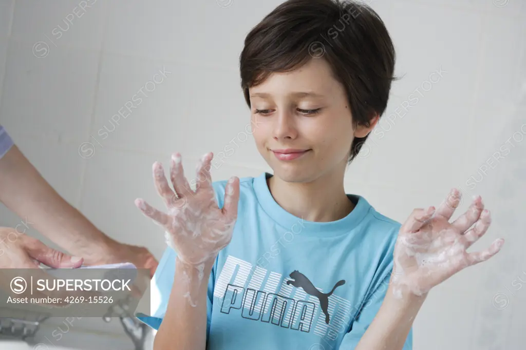 9 years old child washing hands.