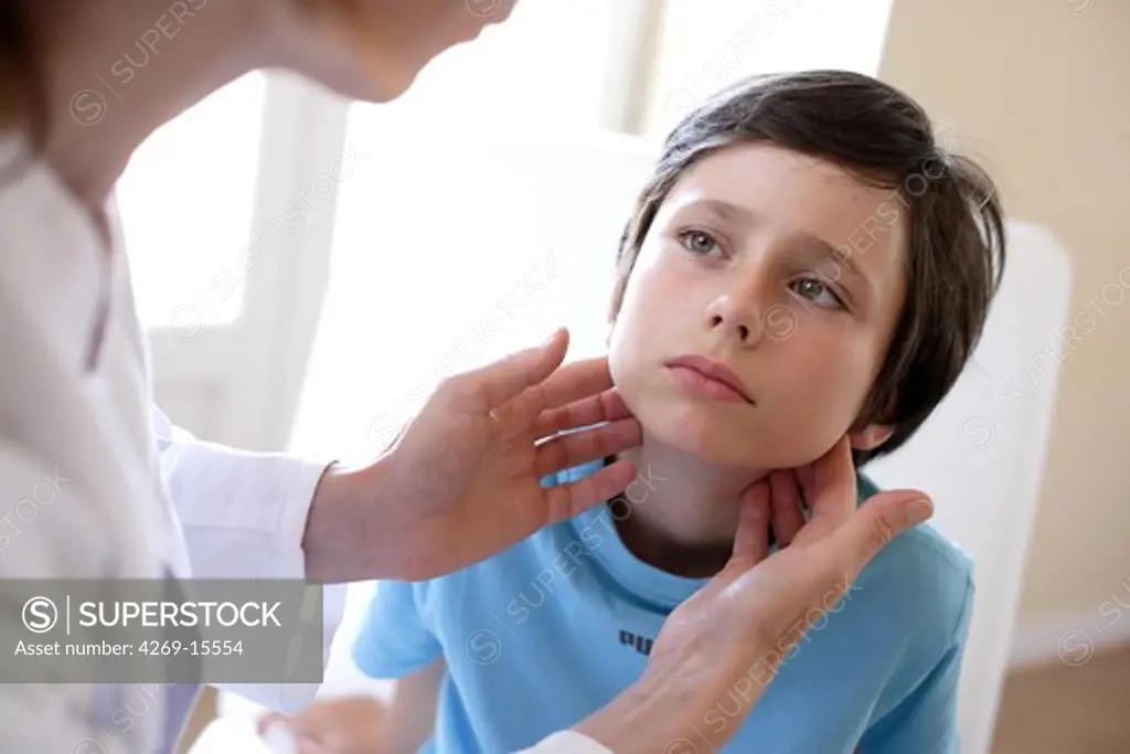 Doctor examining the lymph nodes of 9 years old boy.