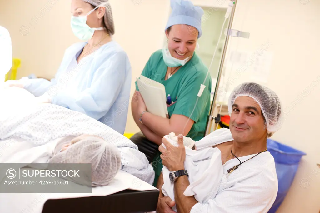 Father carrying his newborn baby using the Kangaroo care methode (skin-to skin). Obstetrics and gynaecology department, Saintonges hospital, Saintes, France.