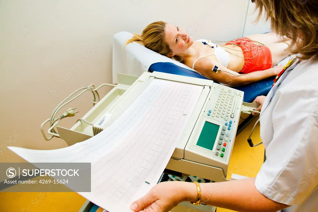 Woman undergoing an electrocardiography (EKG) examination. Department of cardiology, Pitié-Salpêtrière hospital, Paris, France.