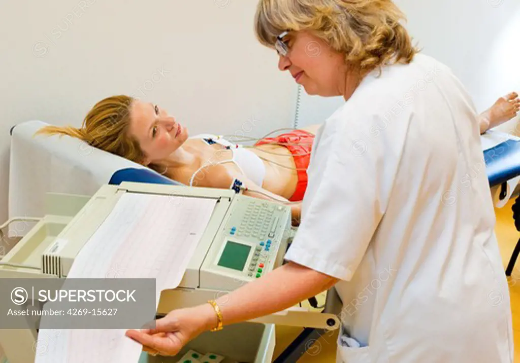 Woman undergoing an electrocardiography (EKG) examination. Department of cardiology, Pitié-Salpêtrière hospital, Paris, France.