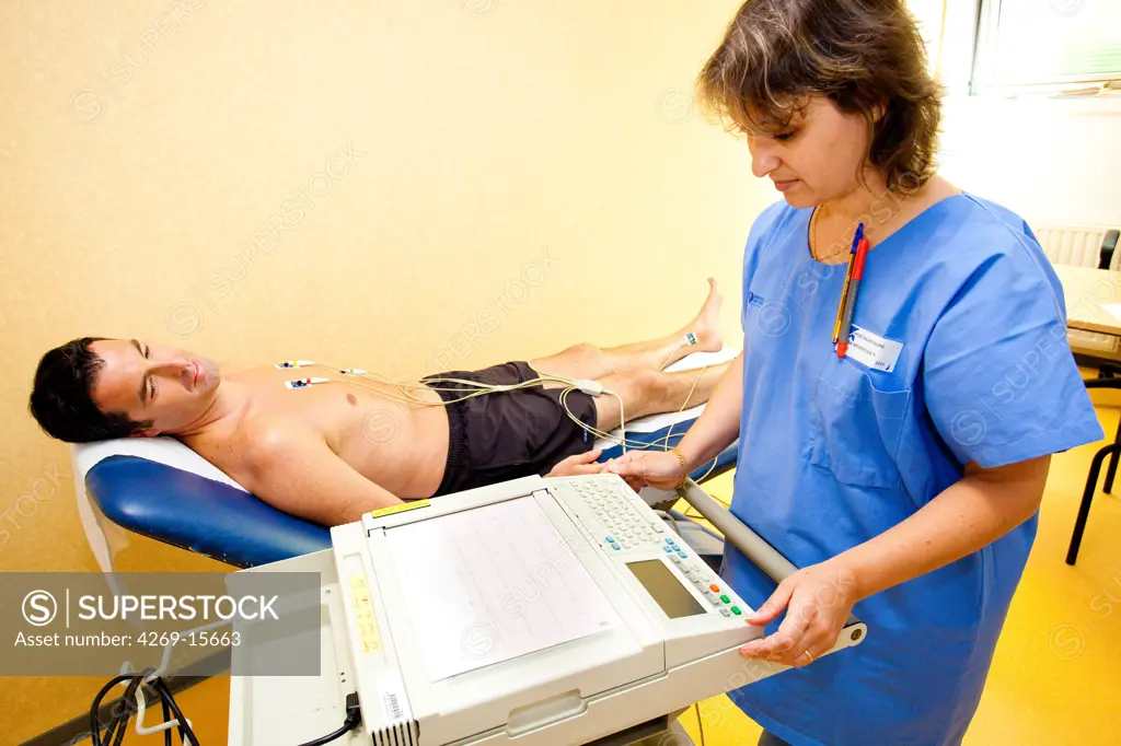 Man undergoing an electrocardiography (EKG) examination. Department of cardiology, Pitié-Salpêtrière hospital, Paris, France.