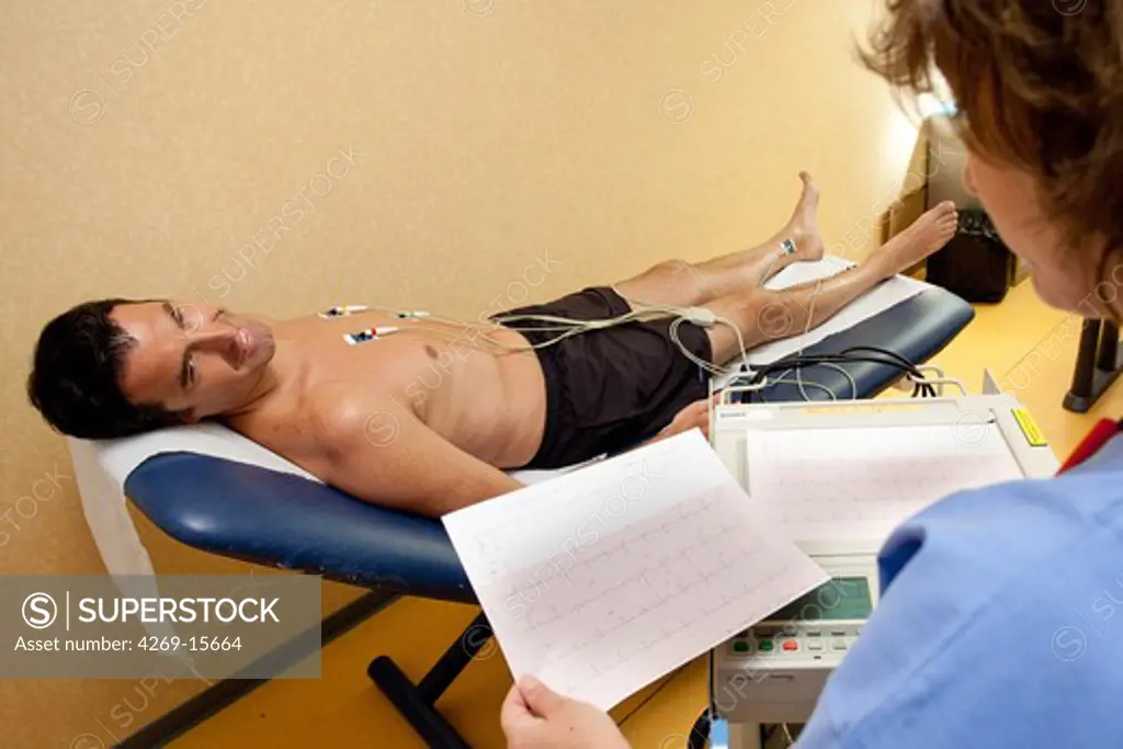 Man undergoing an electrocardiography (EKG) examination. Department of cardiology, Pitié-Salpêtrière hospital, Paris, France.