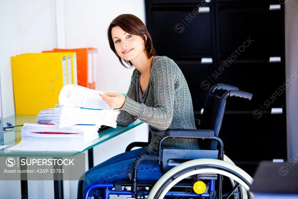 Woman in wheelchair working.