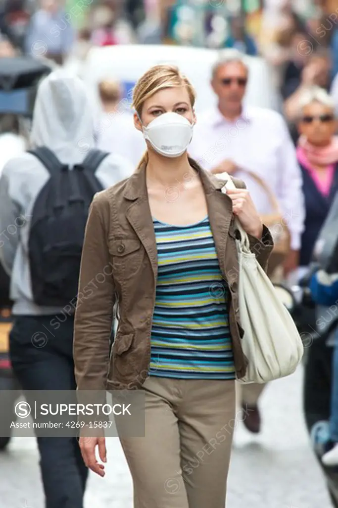 Woman wearing a respiratory protective mask. The French Health Minister recommends to wear this protection mask in case of viral respiratory diseases (cold, bronchitis and flu).