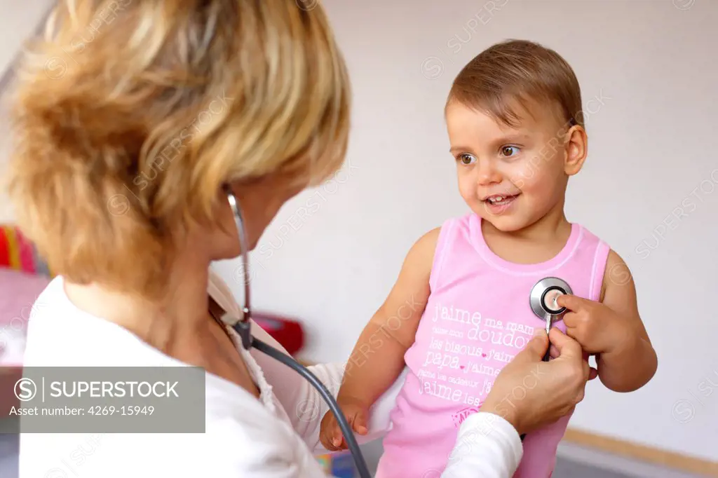 Doctor examining a 18 months old baby with a stethoscope.