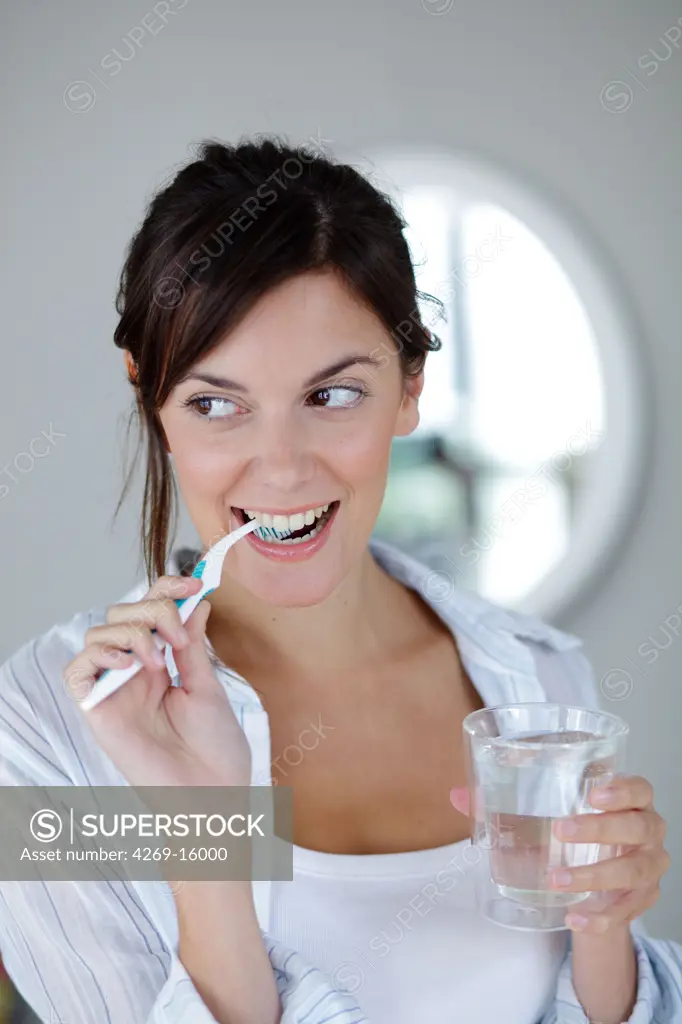 Woman brushing her teeth.