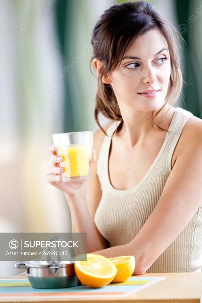 Woman squeezing fresh orange juice.