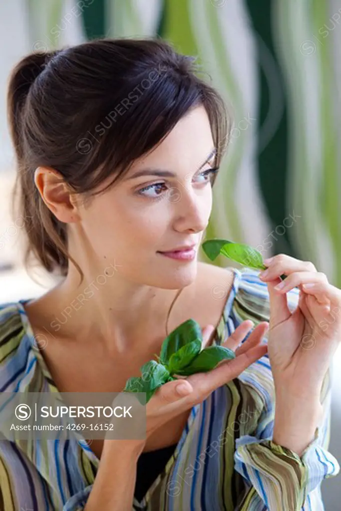 Woman smelling basil.