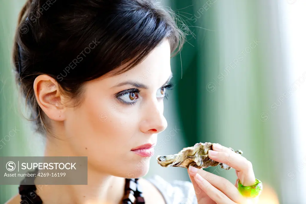 Woman smelling a rotten oyster.