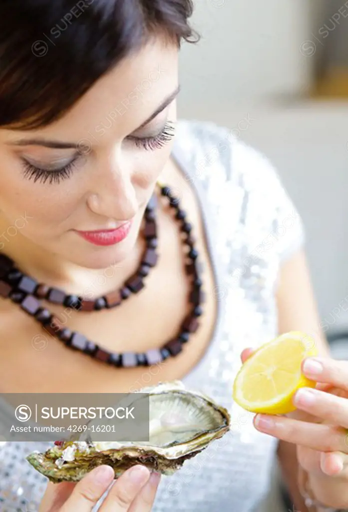 Woman eating an oyster.