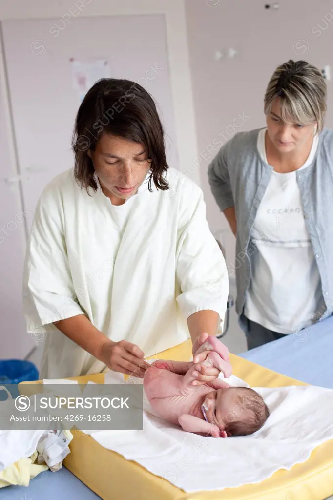 Pediatrician examining a premature newborn baby. Obstetrics and gynaecology department, Saintonges hospital, Saintes, France.