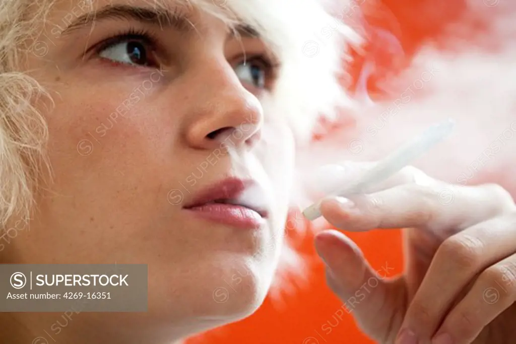 Teenager smoking marijuana or hashish cigarette.