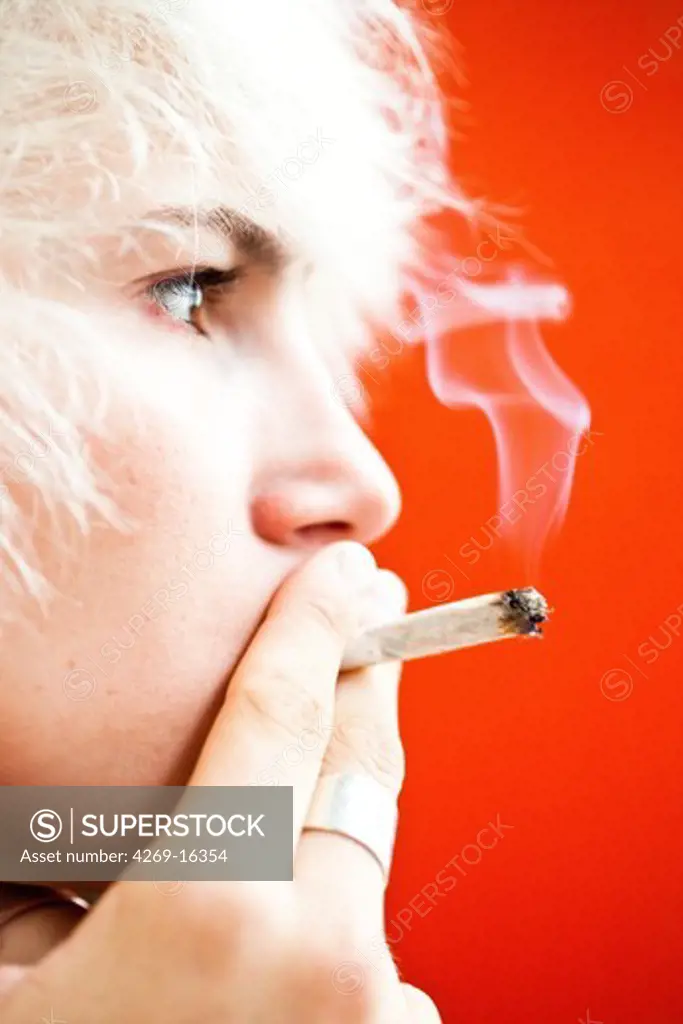 Teenager smoking marijuana or hashish cigarette.
