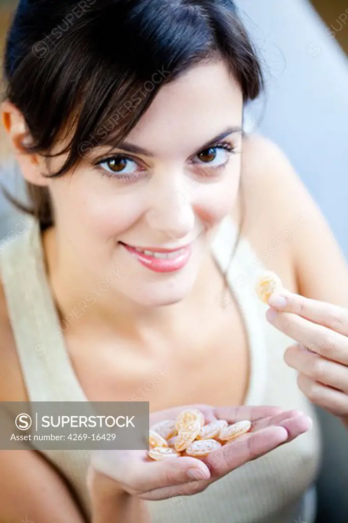 Woman eating honey sweets.