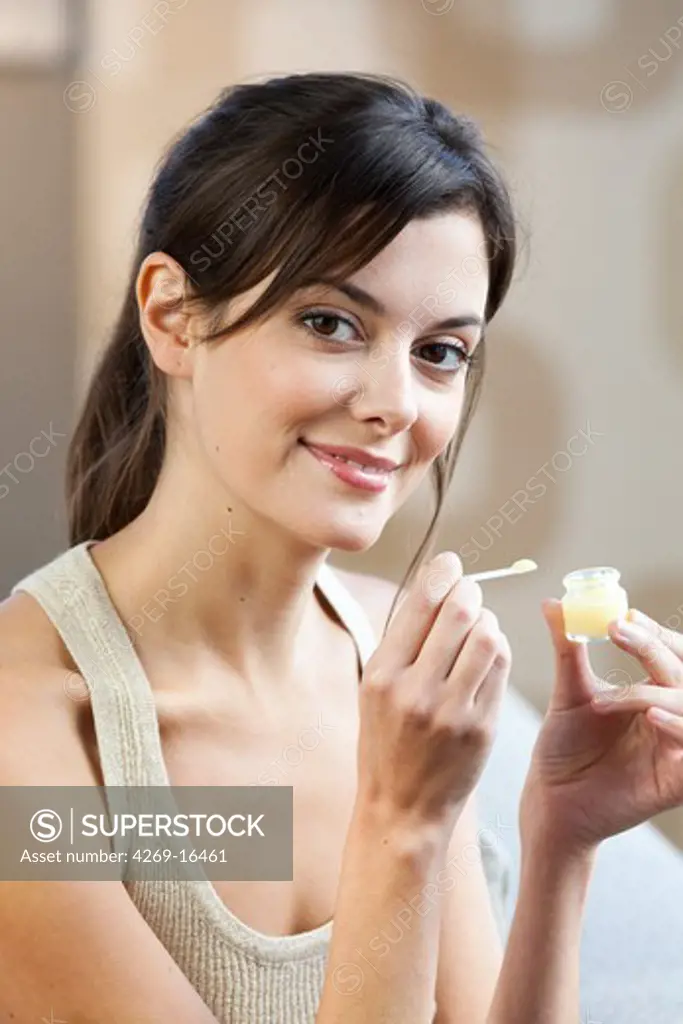 Woman eating royal jelly.