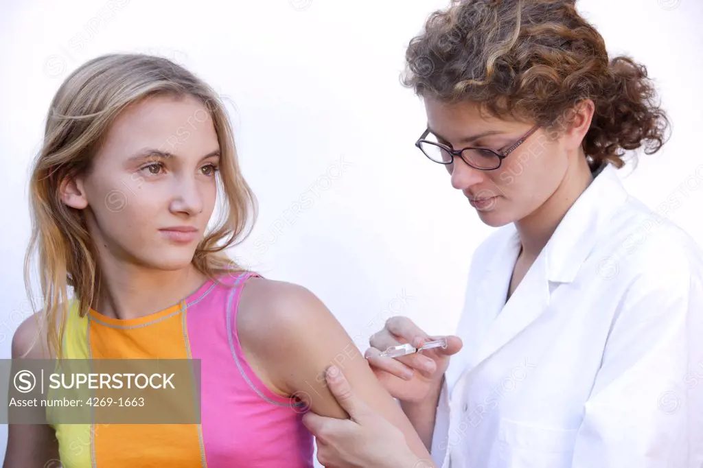 13 years old female teenager receiving vaccination.
