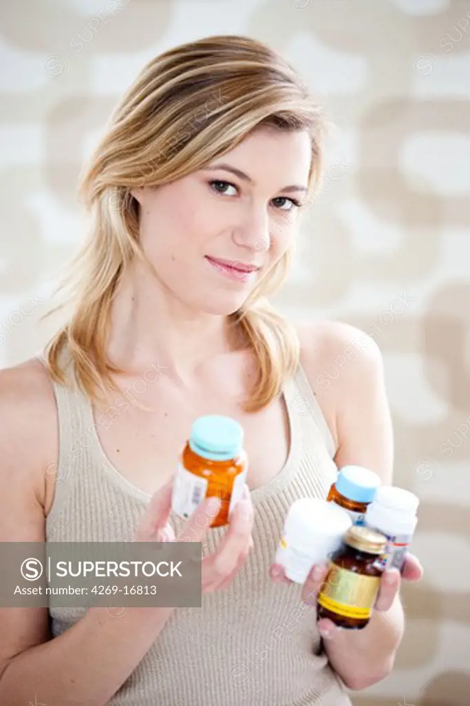Woman taking food supplement.