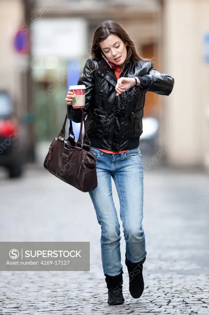 Woman using cell phone in the street.