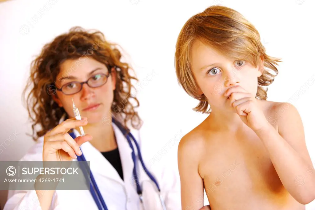 5 years old boy receiving a vaccination from a doctor.