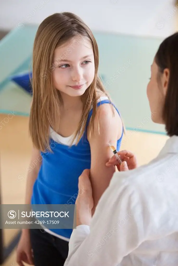 9 years old girl receiving a vaccination.