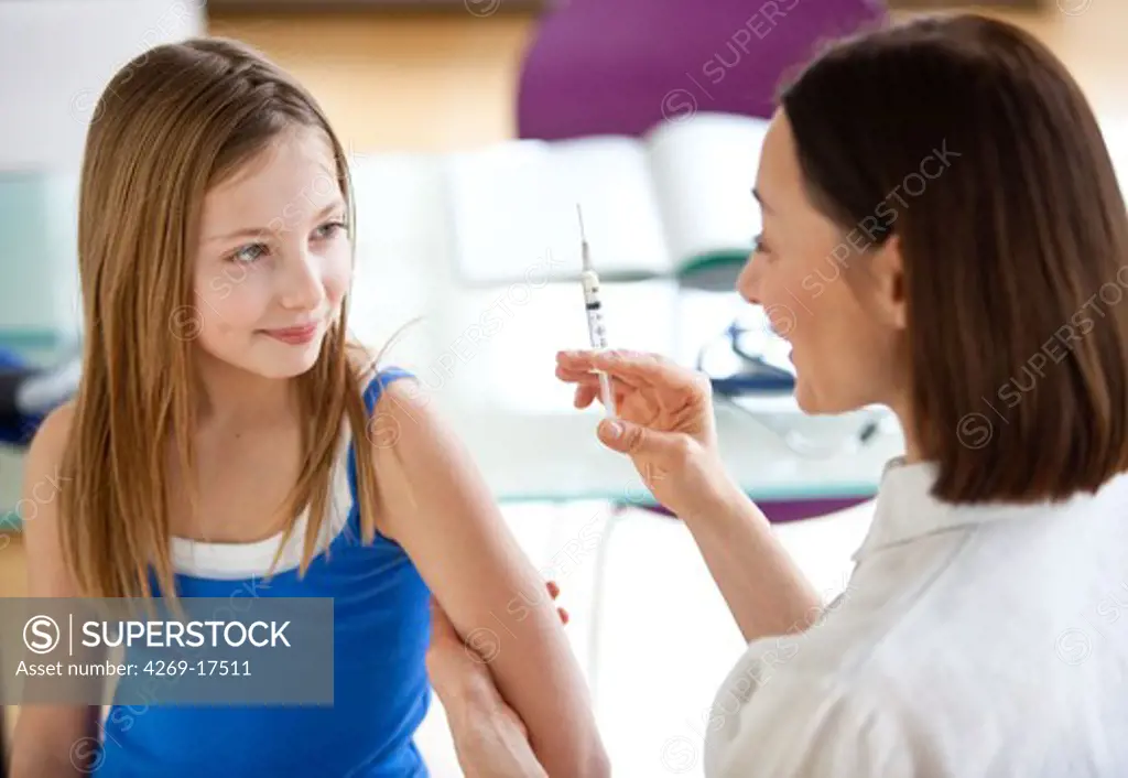 9 years old girl receiving a vaccination.