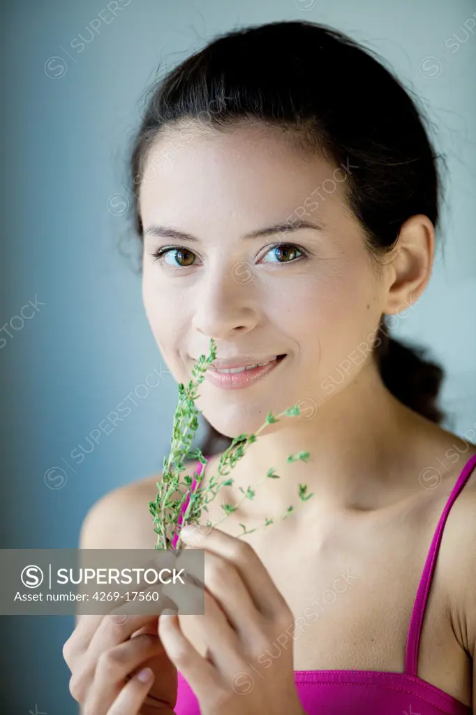 Woman smelling thyme.