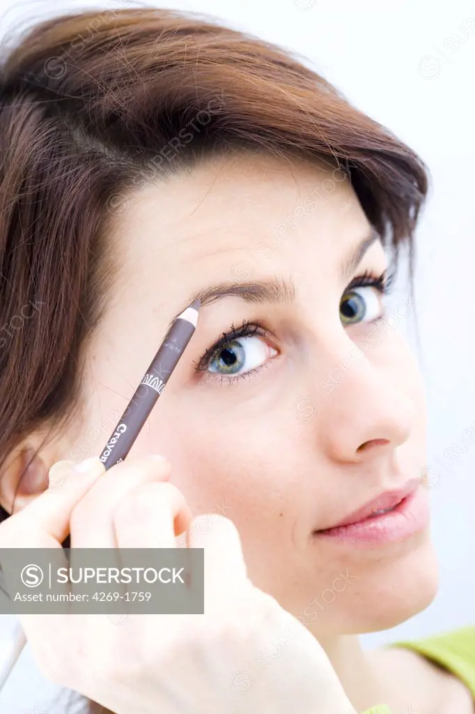 Woman using an eyebrow pencil.
