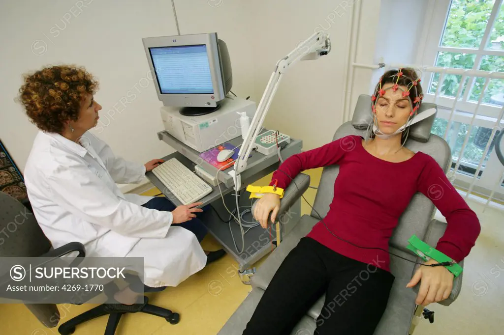 Patient undergoing an electroencephalogram (EEG). The results are recorded directly on a computer.