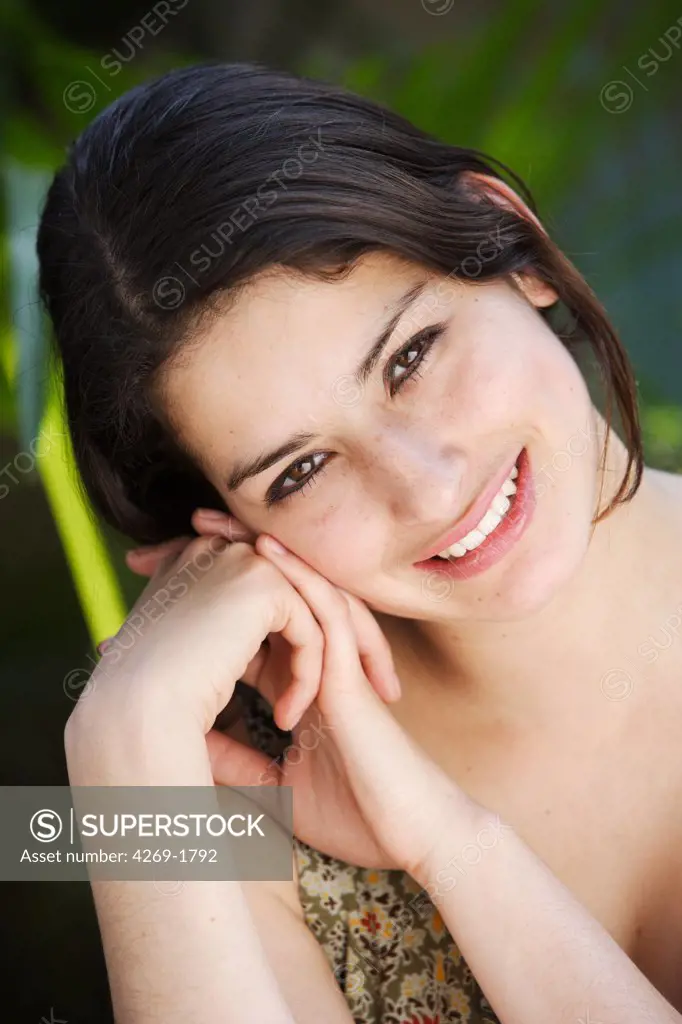Portrait of a 20 years old woman smiling.