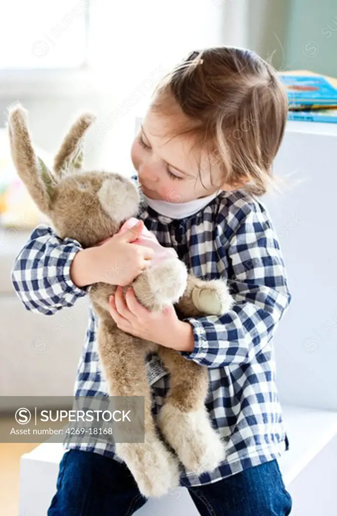 3 years old girl with cuddly toy.