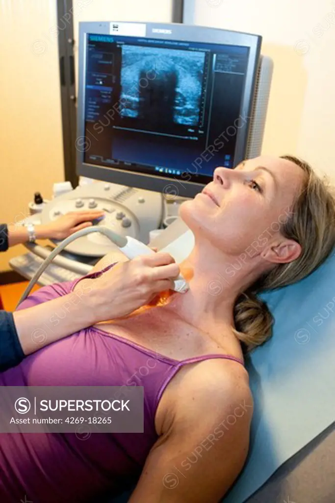 Woman undergoing ultrasound scan of the thyroid.