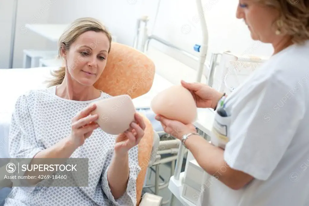 Nurse showing a woman have had a mastectomy different external breast prostheses. Department of Gynecology, Limoges hospital, France.