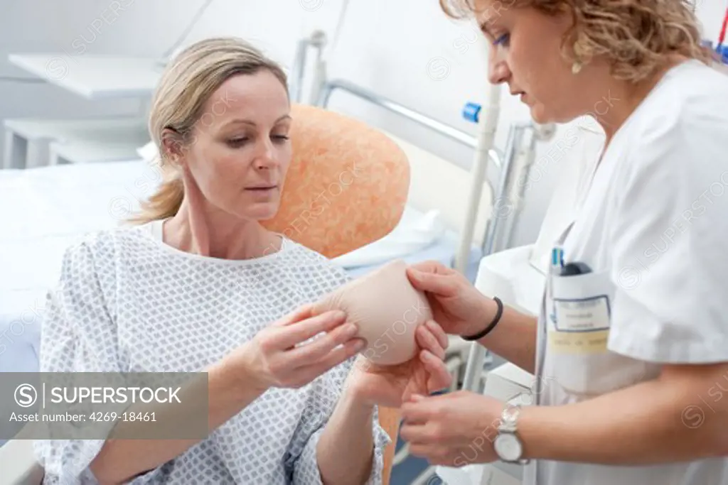 Nurse showing a woman have had a mastectomy different external breast prostheses. Department of Gynecology, Limoges hospital, France.