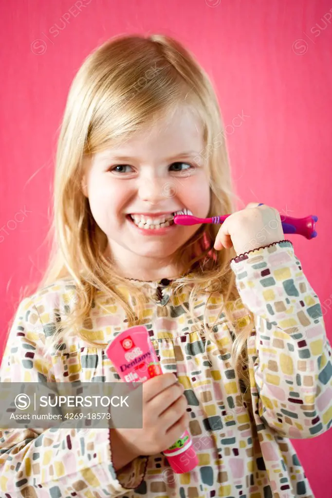 5 years old girl brushing her teeth.