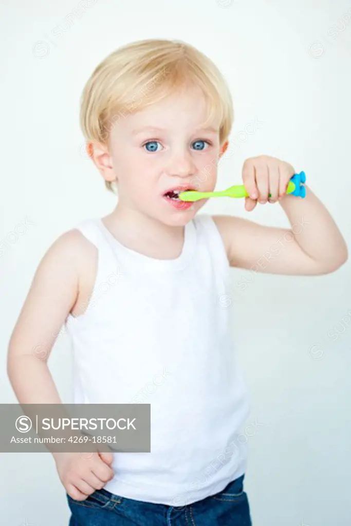 3 years old boy brushing his teeth.