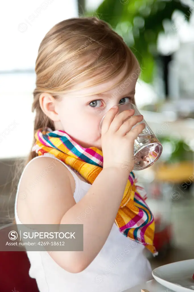 5 years old girl drinking water.
