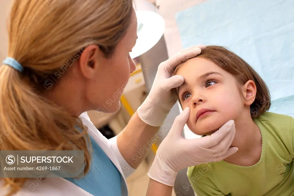 Doctor examining the eye of a 4 years old child.
