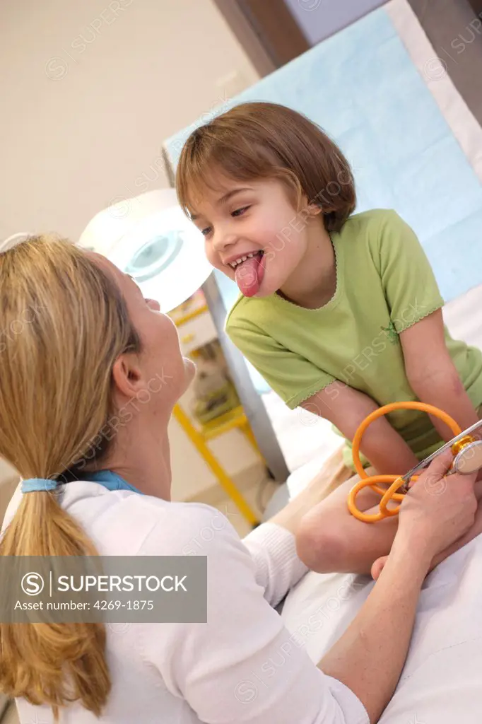 Doctor examining the tongue of a 4 years old child.