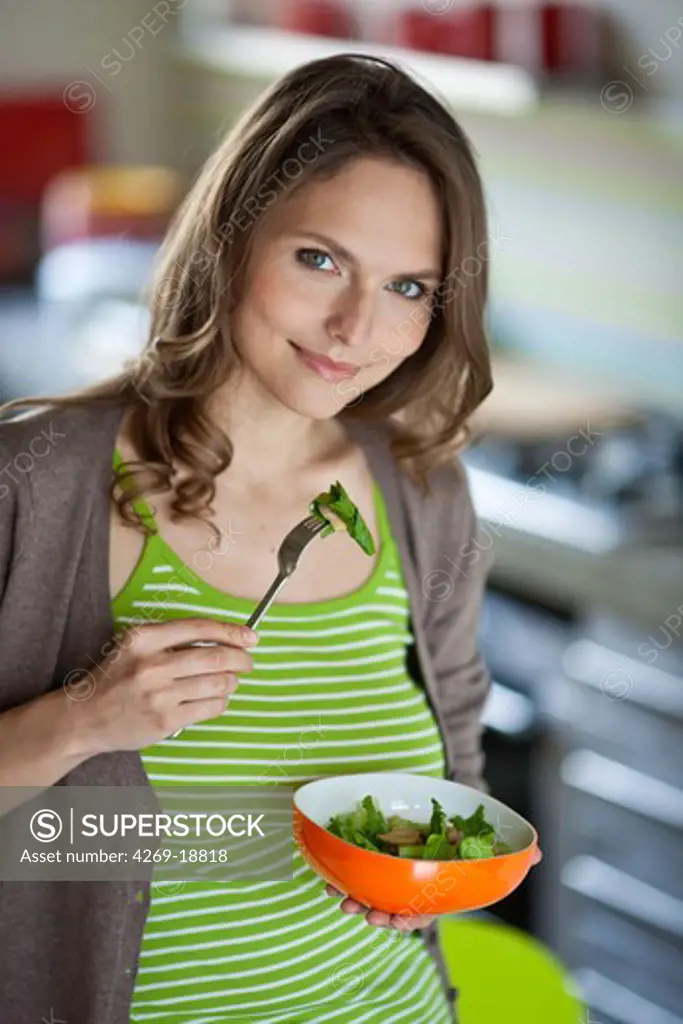 Woman eating broccoli.