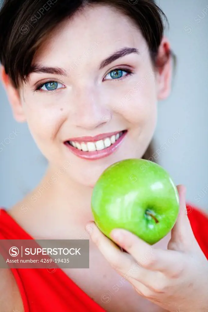 Woman eating an apple.
