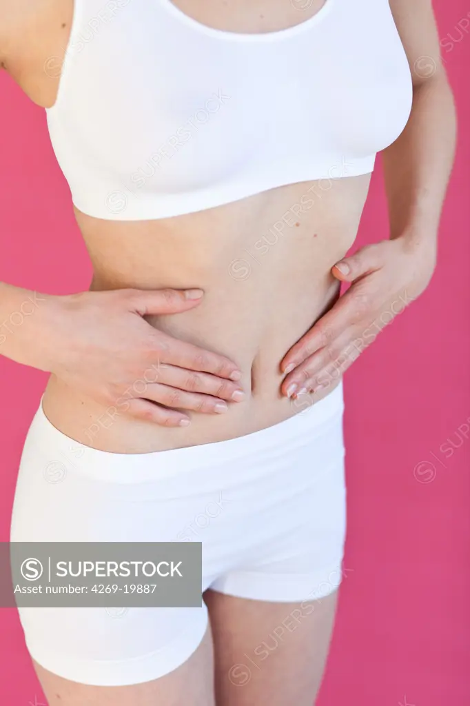 Woman with hands on her belly.