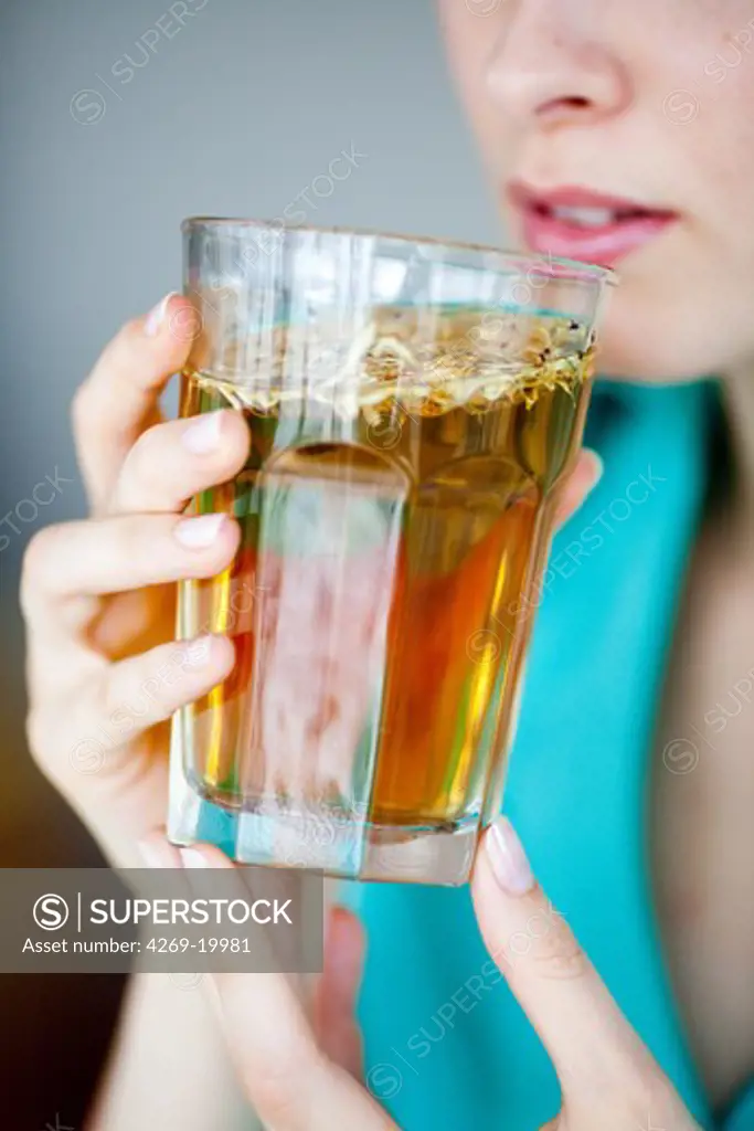 Woman drinking hot beverage.