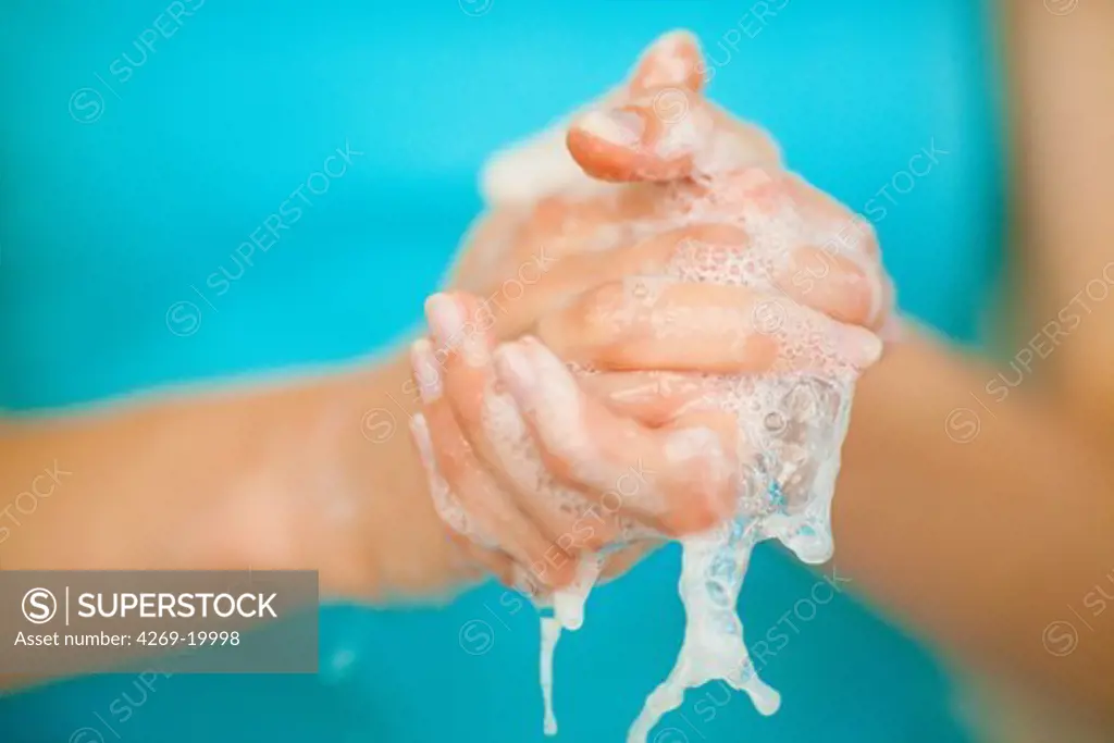 Woman washing her hands.