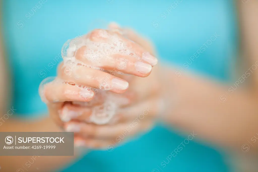 Woman washing her hands.