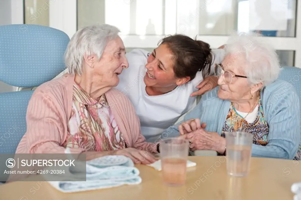 Elderly persons and auxiliary nurse. Residential home for dependent elderly person, Limoges, France.